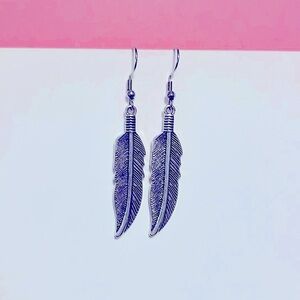 Feather dangle earrings silver tone